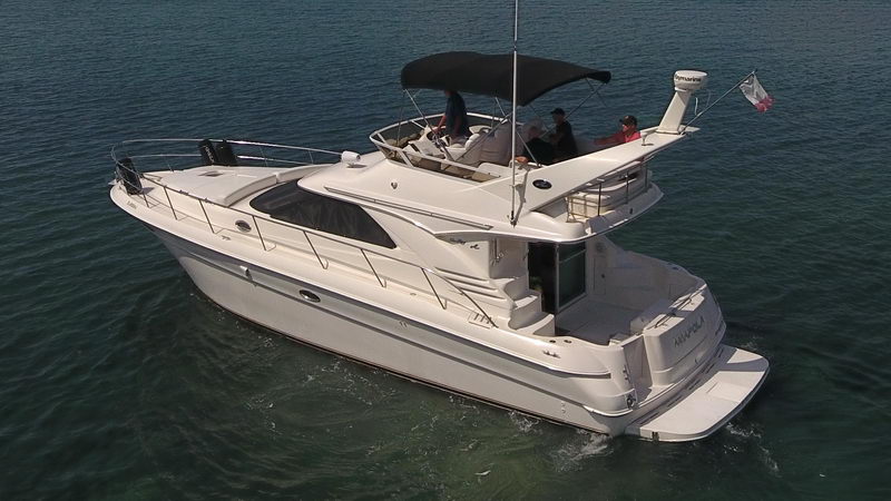 SeaRay 41 Amapola luxury flybridge yacht cruising on open Caribbean waters with guests enjoying the upper deck views