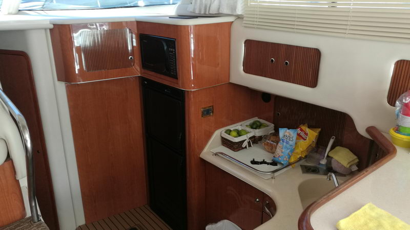 Galley of 41 ft Sea Ray flybridge yacht with microwave, refrigerator, sink and snacks ready for a Cancun charter cruise