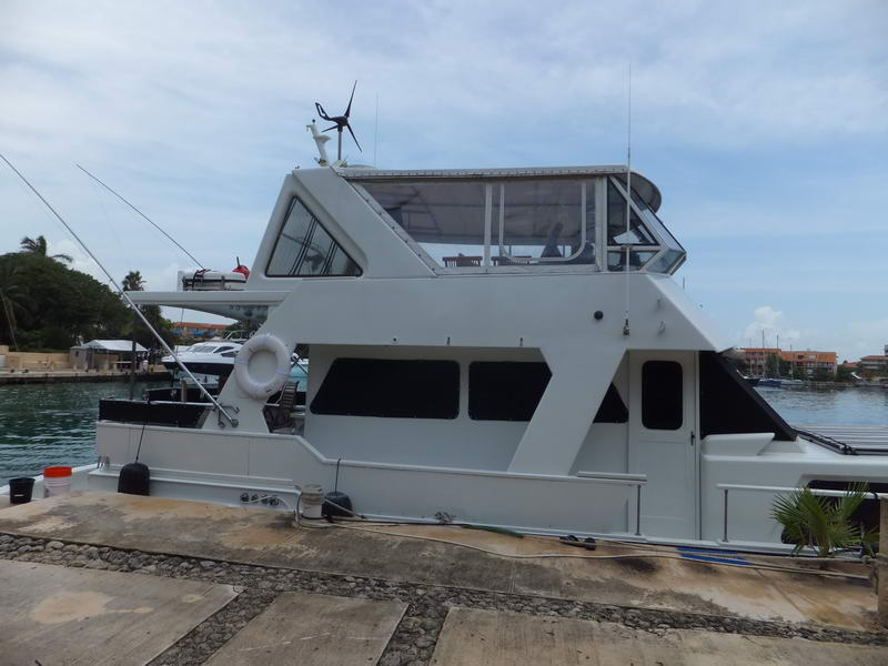 yacht charter group celebrating on deck in turquoise Caribbean waters near Puerto Aventuras