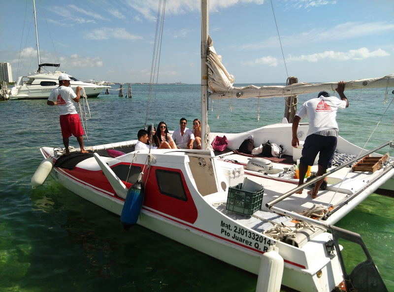Small group aboard Catamaran SeaWind red trimaran at 